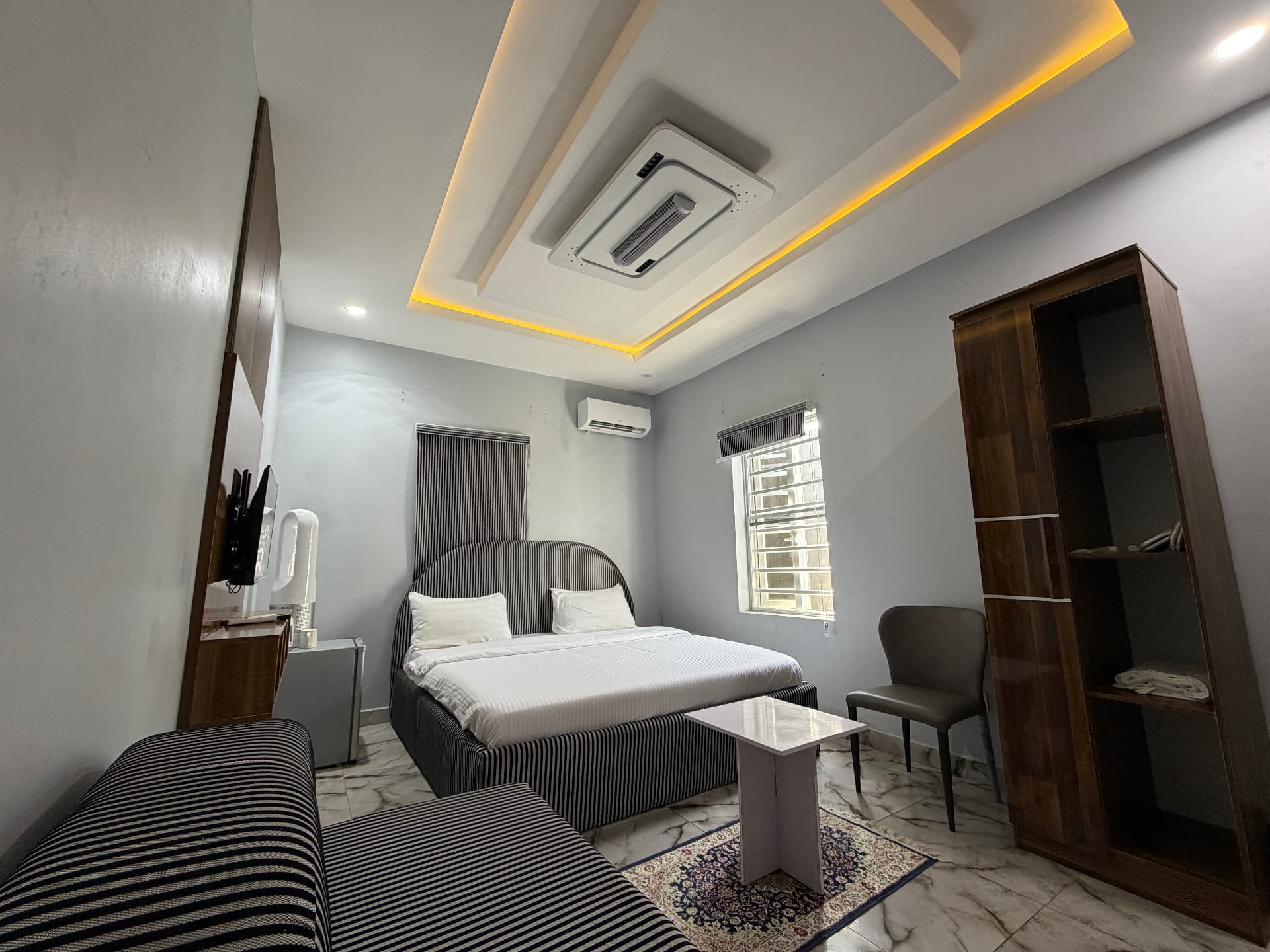 The room in soft grey, bed and lounge chair - Comfort Room at Timeless Haven & Cottage, photo 1 of 4