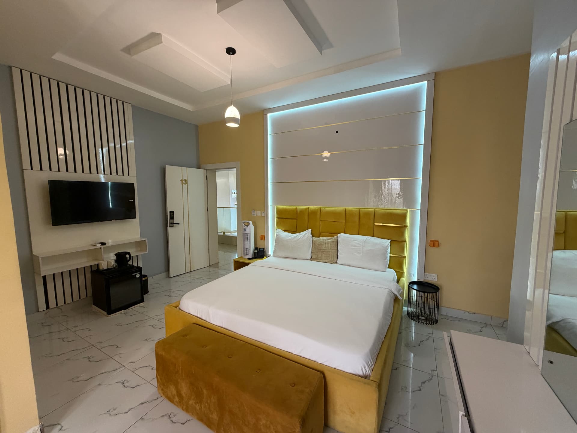 The king bed and its lit headboard - King's Room at Timeless Haven & Cottage, photo 1 of 3
